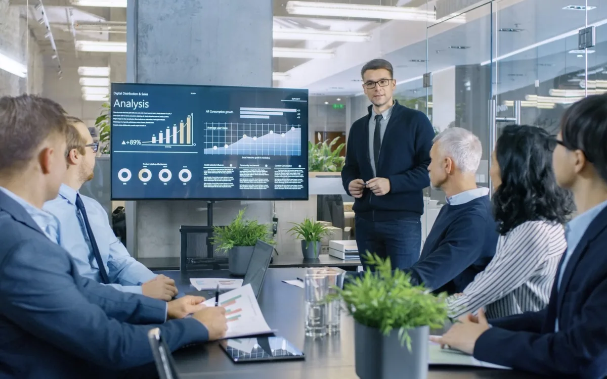 A boardroom reviewing performance data together